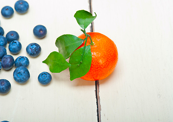 Image showing tangerine and blueberry on white table