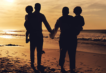 Image showing Beach, holding hands and family in sunset silhouette for summer vacation, holiday and travel love with children. Parents or people together with kids rear by ocean or sea for bonding, peace and care