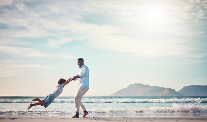 Image showing Happy, spinning and father with son at beach for bonding, support and summer break. Travel, playing and vacation with black man and child swinging together for holiday trip, weekend and happiness