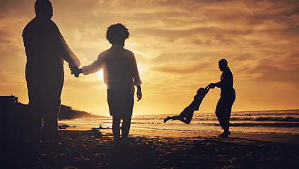 Image showing Silhouette, family and on beach for holiday, quality time and happiness on sand, weekend break and cheerful. Love, parents and children on summer vacation, sunset or bonding together, loving or relax