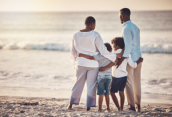 Image showing Black family, hug at beach travel and together watching ocean waves and sunset view, freedom with parents and kids. Man, woman and children outdoor, vacation in Bali, nature and peace with back