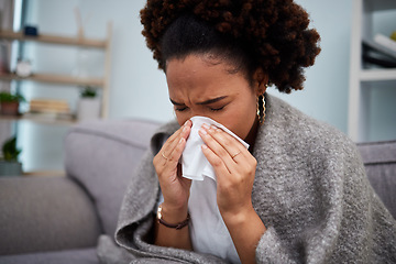 Image showing Sick, couch and woman in a blanket with flu at home, house or apartment with a cold, fever and blowing nose. Virus, sad and female person with a tissue ill on sofa in a lounge with a medical problem