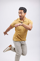 Image showing Dance, movement and man in studio for freedom, energy and performance on white background. Creative, balance and happy, confident and isolated male person or dancer, moving and action pose for mockup