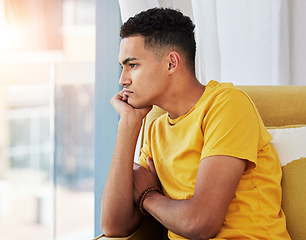 Image showing Thinking, man and home sofa with depression and problem in living room feeling bored and frustrated. Sad, grief and mental health of a male person on couch with anxiety and tired from stress of fail