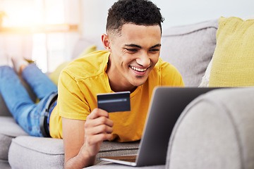 Image showing Credit card, man and laptop for online shopping, digital sale and payment at home. Web banking, ecommerce and website promotion with person buying on computer for deal purchase on app and sofa