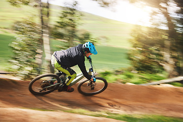 Image showing Mountain bike, man and motion blur in forest for competition, speed or off road adventure on path. Fast athlete, sports and bicycle for contest, cardio race and power in nature, park or action trail