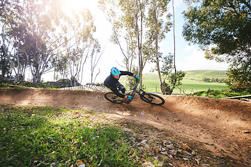 Image showing Mountain bike, man and cycling in forest for competition, freedom and off road adventure on path. Athlete, extreme sports and bicycle for action, cardio race and adrenaline in nature, park and trail