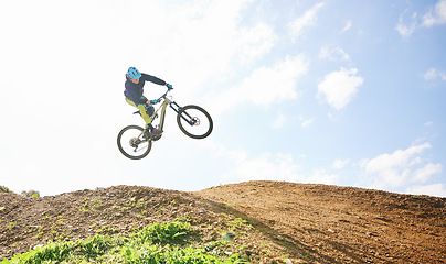 Image showing Mountain bike, man and jump in sky for competition, freedom and off road adventure. Athlete, extreme sports and bicycle in air for action, cardio race and stunt power in nature, path and mockup space