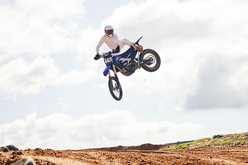 Image showing Sports, jump and man on motorcycle with freedom, energy and power stunt in the countryside for training challenge. Off road, air and male jumping with motorbike for speed, performance or Moto action