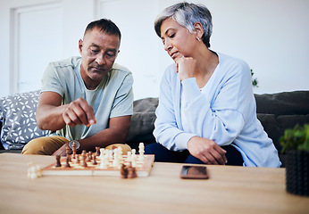 Image showing Senior couple, chess match and home with thinking, strategy and mindset for brain power, relax and bonding. Elderly woman, man and sofa with board game, ideas and brainstorming for challenge in house