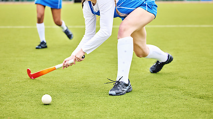 Image showing Hockey, closeup and female athlete playing a game, match or tournament on an outdoor field. Fitness, sports and young woman training or practicing a defence strategy with a stick and ball at stadium.