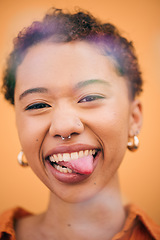 Image showing Happy, woman and tongue out face in studio with smile and confidence feeling silly. Orange background, young portrait and African female person with trendy, modern and student fashion with gen z glow