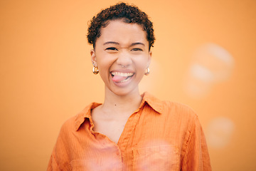 Image showing Portrait, crazy and woman with tongue out in studio for funny, joke or expression against orange background space. Face, emoji and silly young female model pose with good mood, personality and humor