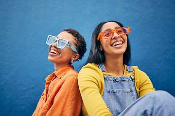 Image showing Sunglasses, fashion and women on blue background by wall with trendy clothes, accessories and style. Happy, summer clothes and face of female people with smile on holiday, vacation and weekend