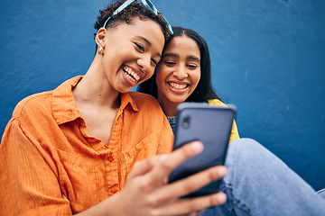 Image showing Phone, happy and women in city on blue background for social media, online post and browse internet. Friendship, smile and female people on smartphone in urban town for bonding, holiday and travel