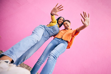 Image showing Selfie, fashion and portrait of women on pink background in city with trendy clothes, stylish and cool outfit. Happy, creative and below of female friends for freedom on holiday, vacation or weekend