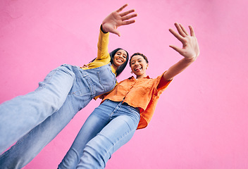 Image showing Happy, fashion and portrait of women on pink background in city with trendy clothes, stylish and cool outfit. Selfie, creative and below of female friends for freedom on holiday, vacation or weekend