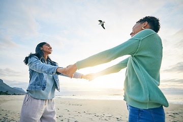 Image showing Holding hands, happy and a lesbian couple at the beach for trust, love and care on a holiday. Smile, summer and lgbt women with freedom, support and love at the sea on a date, vacation or together