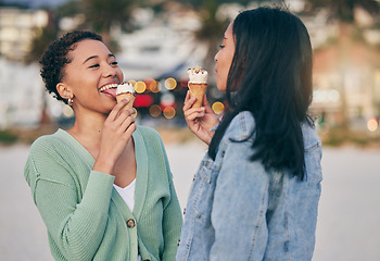 Image showing Ice cream, beach and lesbian couple eating dessert in sunset together on an outdoor vacation or holiday for romance. Lgbtq, pride and women bonding on a summer date for love, relax and happiness