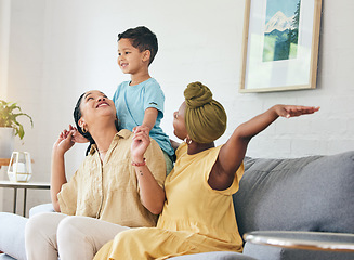 Image showing Lesbian couple, gay family and boy child on a sofa with piggyback, game and fun in their home together. Love, lgbt and women mother in a living room with kid and shoulder, hug and playing in a house