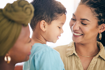 Image showing Love, gay couple and foster boy child hug, bond and sharing happy moment of parenthood in their home. Family, smile and kid with lesbian parents embrace, care and enjoy conversation, playful and free