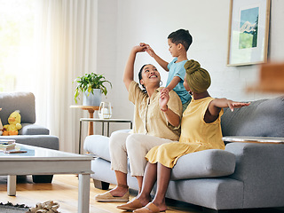 Image showing Family, lesbian couple and boy child on a sofa with airplane, game and fun in their home together. Love, lgbt and women mother in a living room with foster kid and piggyback, bond and play in house