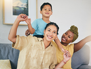 Image showing Airplane, love and gay couple with boy child on a sofa for foster, bonding and playing in their home together. Lesbian, mothers and cheerful kid with parents in living room for piggyback fun games