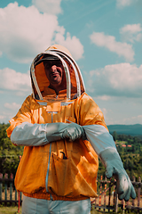 Image showing Beekeeper put on a protective beekeeping suit and preparing to enter the apiary