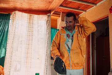 Image showing Beekeeper put on a protective beekeeping suit and preparing to enter the apiary