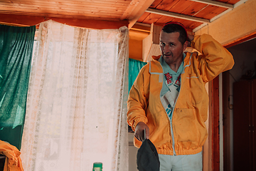 Image showing Beekeeper put on a protective beekeeping suit and preparing to enter the apiary