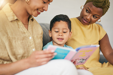 Image showing Reading, gay family and child with a book on a home sofa for knowledge, education and learning. Adoption, lesbian or LGBT women or parents and kid together in a lounge with a story for quality time