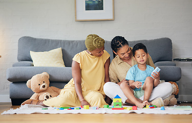 Image showing Playing, gay family and child with toys on a home floor for development, education and learning. Adoption, lesbian or LGBT women or parents and kid together in a lounge for quality time and fun