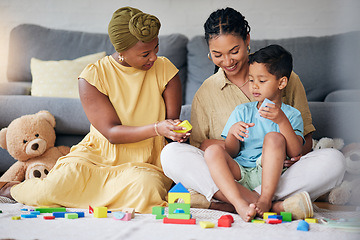 Image showing Toys, child and a gay family playing on a home floor for development, education and learning. Adoption, lesbian or LGBT women or parents and kid together in a lounge for quality time with fun blocks