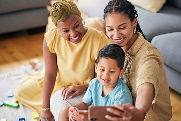 Image showing Lesbian parents, boy and home for selfie, smile and care with toys, post or web blog on floor in living room. Mother, male child and gay women for love, bonding or memory for social network in house