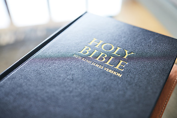 Image showing Closeup, bible book and home for faith, studying religion and mindfulness with holy spiritual scripture. Christian literature, morals and ethics for knowledge, language and worship for Jesus Christ