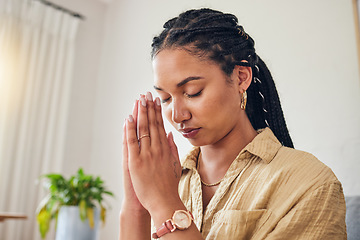 Image showing Hands, worship and woman praying in her living room for hope, help or holy forgiveness in her home. God, pray and Christian female in prayer for blessing, grace and gratitude to Jesus Christ in house