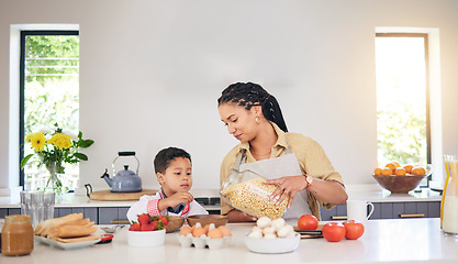 Image showing Breakfast, family and a mother and child cooking, baking or helping with food in the kitchen. House, eating and a boy kid and a young mom teaching during lunch or for dinner together while hungry