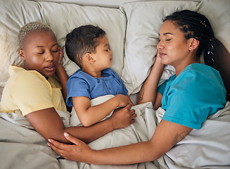 Image showing Sleeping, gay family and relax in bed from above, hug and resting in their home together. Lgbt, sleep and lesbian couple with foster boy child in bedroom dreaming, care and adoption, comfort and love