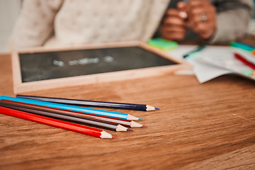 Image showing Hands, helping and child with pencils on table for remote learning, education or writing on board, paper or desk in house. Closeup, drawing and creative kid working on art with parent in home