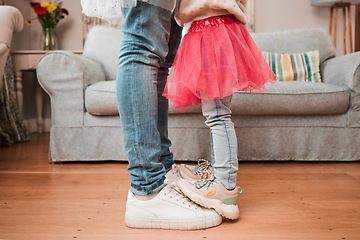 Image showing Dance, feet and home with father and daughter in living room for ballet, princess and love. Music, care and learning with closeup of man and child in family house for helping, youth and energy