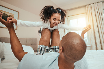 Image showing Dad, child and playing on bed flying for fun, quality time or bonding together in home, bedroom or girl in airplane game. Happy, father and daughter in air with knees and arms raised with freedom