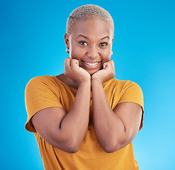 Image showing Portrait, smile and fashion with a black woman on a blue background in studio for trendy clothes style. Happy, beautiful and confidence with a young female person posing in a relaxed clothing outfit