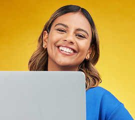 Image showing Smile, laptop and portrait of woman on yellow background, networking and online influencer with internet connection. Computer, studio and face of happy content creator with social media, email or web