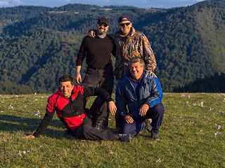 Image showing Friends at a community gathering. A group of friends posing on a beautiful natural landscape