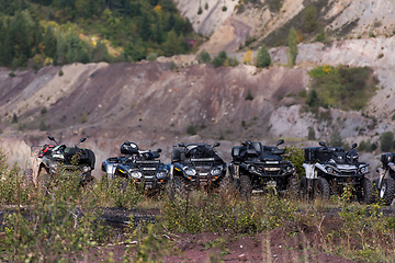 Image showing Various ATV quad motors in the forest area ready for adventurous driving