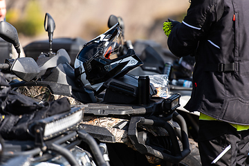 Image showing A man is preparing for an adventurous ride on a quad bike