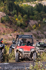 Image showing Various ATV quad motors in the forest area ready for adventurous driving