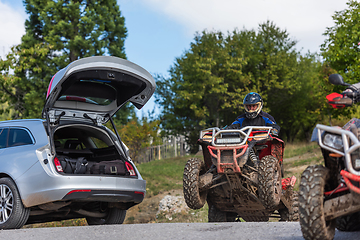 Image showing Adventurous driving of ATV motorbikes. A man drives a quad bike on dangerous roads