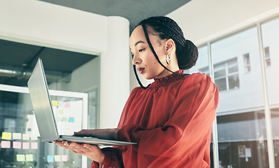 Image showing Woman in office with laptop, research and website for ideas at window, website for business plan and brainstorming startup proposal. Thinking, typing and businesswoman on computer for internet search