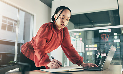 Image showing Woman on laptop, research and writing notes, ideas on website for business plan or brainstorming proposal process. Thinking, businesswoman with pen and book on computer, standing in startup office.